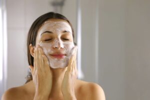 Woman performing skincare routine at home