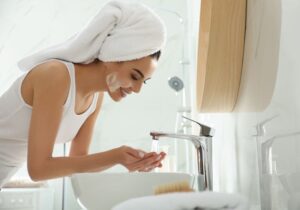 Woman washing her face before microdermabrasion appointment