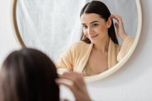 Woman with beautiful skin sitting in front of mirror